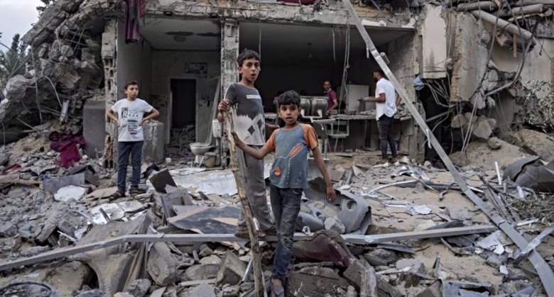 Palestinian children look at the destruction after Israeli airstrike in Gaza